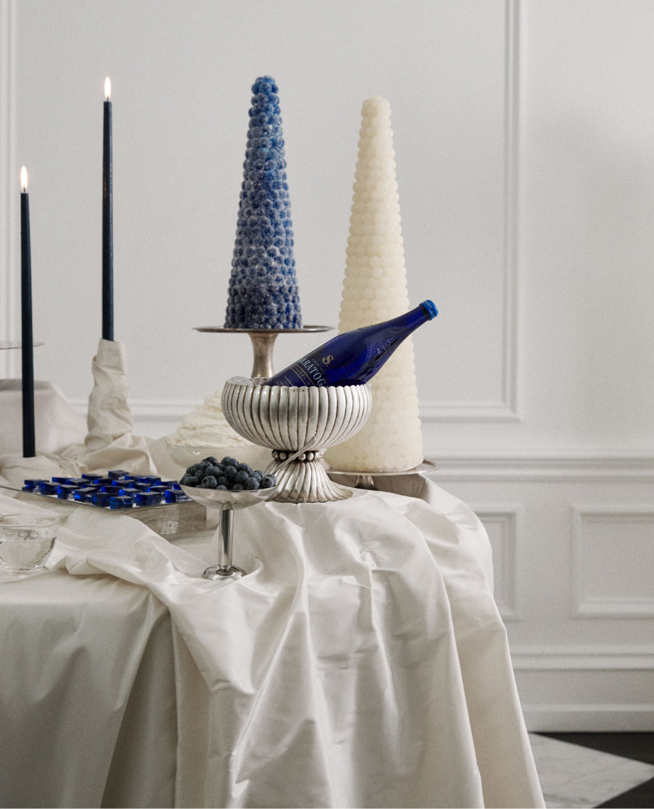 elegant party table decorated with desserts and saratoga spring water in antique silver