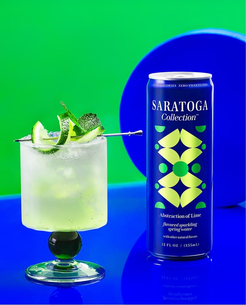 The Saratoga Collection Abstraction of Lime Mojito cocktail next to a can of Saratoga Collection Abstraction of Lime.